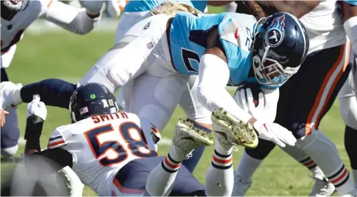  ?? WESLEY HITT/GETTY IMAGES ?? The Bears’ defense held Titans running back Derrick Henry (above) to 68 yards on 21 carries and sacked quarterbac­k Ryan Tannehill (left) three times Sunday in Nashville, Tenn.