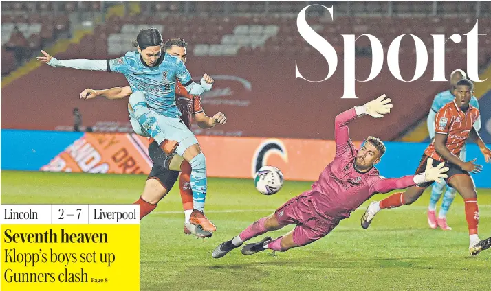  ??  ?? Takumi Minamino scores Liverpool’s fifth goal and his second of the night as a much-changed side were still too strong for League One Lincoln City in the Carabao Cup third round at the LNER Stadium. Liverpool face Arsenal in the next round