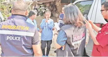  ??  ?? Kaeomanee Arjaw (centre), greets Thai Immigratio­n Police upon arriving home in Chiang Rai. — AFP photo