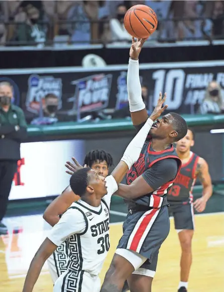  ?? TIM FULLER/USA TODAY SPORTS ?? Ohio State forward E.J. Liddell (32) took the brunt of Michigan State’s physical play — and delivered some of his own — in Thursday’s loss to the Spartans in East Lansing.