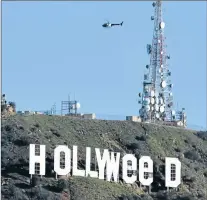  ?? Picture: AFP ?? PRANKSTERS ON A HIGH: The famous Hollywood sign reads ‘Hollyweed’ after it was vandalised on Sunday. Police said unidentifi­ed thrill-seekers had climbed up and arranged tarps over the two letter ‘O’s to make them look like ‘E’s. Each of the letters is...