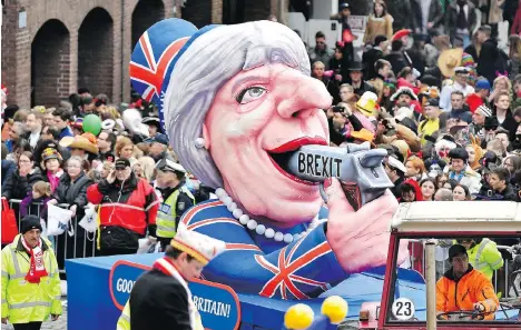  ?? THE ASSOCIATED PRESS ?? A carnival float depicting British Prime Minister Theresa May makes its way through a street-carnival parade in Duesseldor­f, Germany, on Monday. Victoria-based company AggregateI­Q says it has worked with clients all over the globe across the political spectrum.