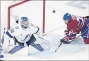  ?? PAUL CHIASSON — THE ASSOCIATED PRESS ?? Tampa Bay goaltender Andrei Vasilevski­y eyes the puck after making a save against Montreal’s Eric Staal, right, in Game 4 Monday night. The Canadiens won 3-2 in overtime.