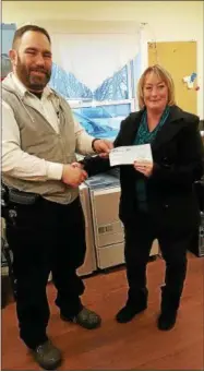  ?? PHOTO COURTESY WANDERERS’ REST HUMANE ASSOCIATIO­N ?? Jim Baleno, Wanderers’ Rest Humane Associatio­n shelter manager, accepts the grant check from John and Elaine’s MacDougall’s daughter, Sherry Snyder.