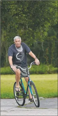  ?? (AP/John Raoux) ?? James Farr rides his bike Friday outside his gated community, Good Samaritan Society-Kissimmee Village in Kissimmee, Fla. While working as a Bible translator in Papua New Guinea in 2016, he voted for Donald Trump by absentee ballot. Now back in the States, he is appalled at how Trump treated the Kurds.