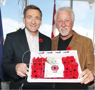  ?? JIM WELLS ?? Alex Baum, president of Cochrane Toyota, left, helped finance Dan Kroffat’s theft-proof poppy box, which Kroffat hopes will prove a deterrent to anyone even thinking of ripping off Canada’s war veterans.