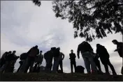  ?? GREGORY BULL — THE ASSOCIATED PRESS ?? Migrants arrive at a bus stop after leaving a processing facility in San Diego.