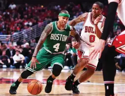  ?? (Reuters) ?? BOSTON CELTICS guard Isaiah Thomas (left) dribbles the ball while being defended by the Chicago Bulls’ Isaiah Canaan during the first half of Game 4 of the teams’ first-round playoff duel on Sunday night. Thomas finished with a game-high 33 points as...