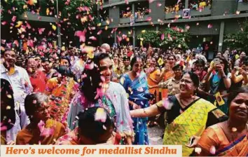  ?? PTI ?? Rio Olympics silver medallist P.V. Sindhu is welcomed by students at St. Ann’s College for Women in Hyderabad, where the badminton star is a final year MBA student, yesterday.