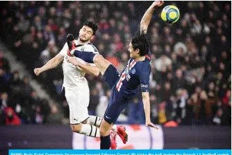  ??  ?? PARIS: Paris Saint-Germain’s Uruguayan forward Edinson Cavani (R) kicks the ball during the French L1 football match between Paris Saint-Germain (PSG) and Girondins de Bordeaux at the Parc des Princes stadium in Paris. — AFP