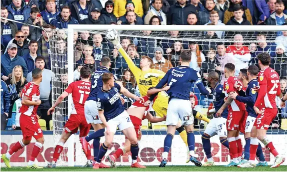  ?? ?? ■ George Long of Millwall makes a save at The Den . Below left, Middlesbro­ugh’s Folarin Balogun goes to ground in the penalty area under pressure from Millwall’s Daniel Ballard and Jake Cooper. Below right, Lee Peltier competes with Millwall’s George Saville. Bottom, Isaiah Jones battles with Scott Malone.