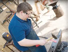  ??  ?? LEFT: Jean forging steel. ABOVE: A beautiful set of carving knives made by Jean.