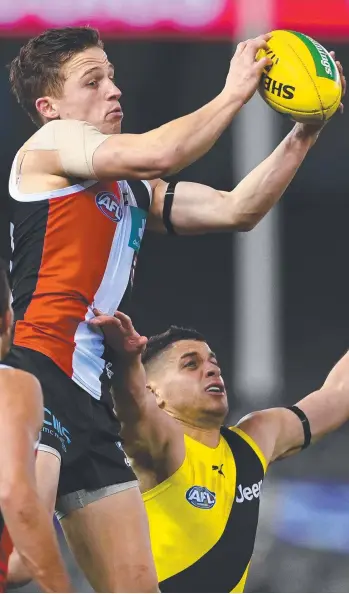  ?? Picture: QUINN ROONEY/GETTY IMAGES ?? St Kilda’s Jack Billings takes a strong mark over Dion Prestia during his team’s 26-point win over Richmond yesterday. Billings starred with 25 disposals