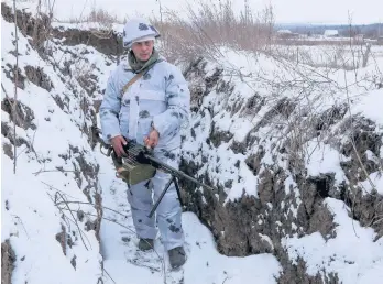  ?? ALEXEI ALEXANDROV/AP ?? A soldier stands in a trench in territory controlled by pro-Russian militants Tuesday in Slavyanose­rbsk, Ukraine.