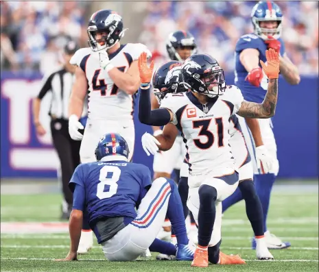  ?? Alex Trautwig / Getty Images ?? The Broncos’ Justin Simmons (31) reacts after tackling Giants quarterbac­k Daniel Jones during the fourth quarter on Sunday.