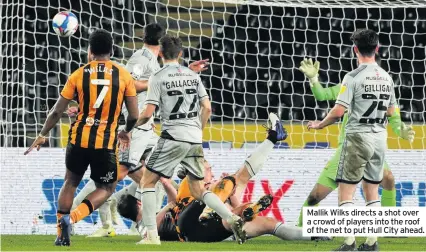  ??  ?? Mallik Wilks directs a shot over a crowd of players into the roof of the net to put Hull City ahead.