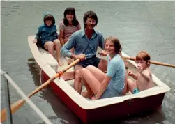  ??  ?? Above, with his four children, on one of their many sailing holidays.
Left, with colleagues from Shibutani, Interlock’s distributo­r in Japan.