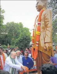  ?? PTI ?? BJP president Amit Shah pays tribute to Pt Deen Dayal Upadhyaya at party office in Bhubaneswa­r on Friday.