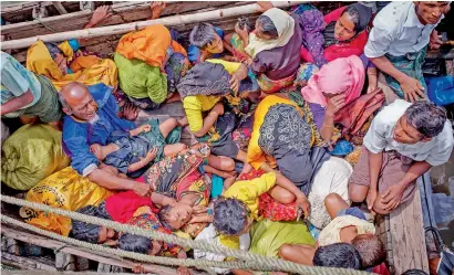  ?? AFP ?? Rohingya refugees arriving by boat at Shah Parir Dwip in Bangladesh after fleeing ethnic cleansing in Myanmar. —