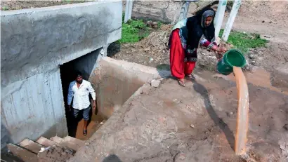  ?? AFP ?? Villagers living along the India-Pakistan border remove water from their bunker on Tuesday, after Indian fighter jets launched an airstrike in Pakistan. Kashmiri expats in the UAE, whose families live on the border, are calling for an end to the conflict. —
