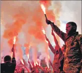  ?? AP ?? Soldiers hold flares as they attend the funeral of activist and soldier Roman Ratushnyi in Kyiv, Ukraine, on Saturday.