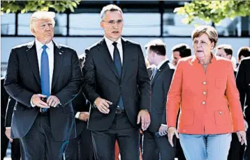  ?? EMMANUEL DUNAND/GETTY-AFP ?? President Donald Trump arrives at a ceremony with NATO chief Jens Stoltenber­g and German leader Angela Merkel.