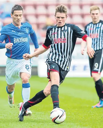  ??  ?? Neil Mccann has been a big believer in Lewis Spence ever since he was a teenager starting out at Dunfermlin­e. Spence, keen to make his mark at Dens, was undaunted by making his Dundee league debut at Ibrox, far right. Pictures: Sns/steven Brown.
