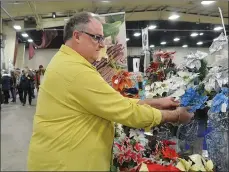  ?? NEWS PHOTO MO CRANKER ?? Ken Deering makes his wreath display look nice and sharp Saturday during the Something for Everyone Market held at the Stampede Grounds.