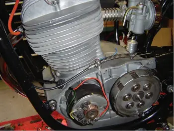  ??  ?? The dynamo, dry outboard clutch with drive sprocket lurking behind, nice newish brushes and new red and green wires