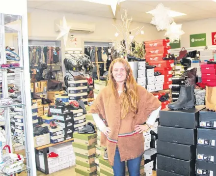  ?? Richard Mackenzie ?? Siobhan Briand surrounded by the numerous gift ideas at Trendy’s Shoe Shoppe in Antigonish. The business is one of several participat­ing in the Shop Local: Antigonish By Choice holiday campaign.