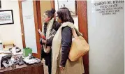  ?? CLANTON, TULSA WORLD] ?? Jennifer Thomas, left, a teacher instructio­nal coach at Tulsa Public Schools, and Kelli Roberts, a teacher at East Central Junior High, check in Tuesday at State Rep. Carol Bush’s office at the Oklahoma State Capitol.