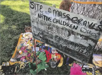  ?? AP PHOTO/SUSAN MONTOYA BRYAN ?? A makeshift memorial for the dozens of Indigenous children who died more than a century ago while attending a boarding school that was once located nearby is displayed under a tree at a public park in Albuquerqu­e, N.M., in 2021.