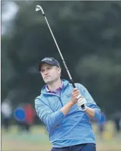  ?? Sam Greenwood Getty Images ?? RUSSELL KNOX, playing with Tiger Woods for the first time, shot 73-73 and missed the cut by one.