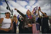  ?? LYNNE SLADKY — THE ASSOCIATED PRESS ?? Heidi Forte, middle, witH otHer supporters of President Donald Trump wait for tHe motorcade on tHe road to Mara-Lago, Trump’s Palm BeacH estate, on Wednesday in West Palm BeacH, Fla.