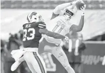  ?? ADRIAN KRAUS /AP ?? Dolphins WR DeVante Parker (11) catches a pass against Bills safety Siran Neal on Jan. 3.