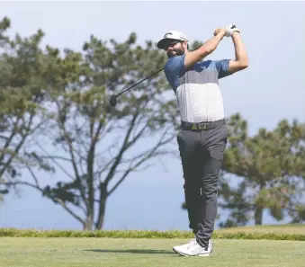  ?? HARRY HOW/GETTY IMAGES ?? Adam Hadwin of Canada plays his shot from the second tee during Thursday's first round of the U.S. Open at Torrey Pines Golf Course in San Diego. Hadwin is in the hunt after firing a 1-under 70.