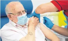  ?? DAN CHARITY/POOL VIA REUTERS ?? George Dyer, 90, receives the first Pfizer/BioNTech COVID-19 vaccine in London on Tuesday.