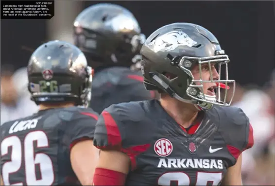  ??  ?? Complaints from traditiona­list fans about Arkansas’ anthricite uniforms, worn last week against Auburn, are the least of the Razorbacks’ concerns.