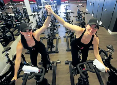  ?? CLIFFORD SKARSTEDT/EXAMINER ?? Full Tilt Cycle co-owners Sadie Cavanagh, left, and Erin Marshall during the opening of the new health and fitness cycle studio Wednesday on Hunter Street.