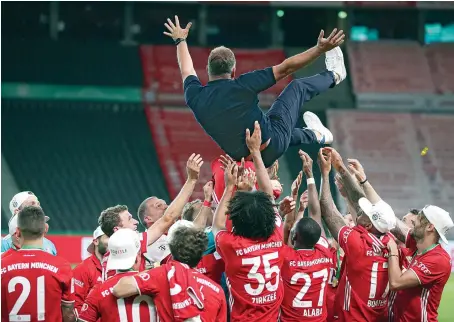  ?? AP ?? Bayern’s head coach Hans-Dieter Flick and his players after winning the German soccer cup (DFB Pokal) final match against Bayer Leverkusen on Saturday.