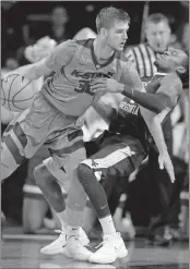  ??  ?? Kansas State forward Dean Wade (32) runs into West Virginia guard Daxter Miles Jr. (4) during the first half in Manhattan, Kan., on Monday.