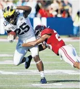  ?? JOE ROBBINS/GETTY ?? Michigan running back Hassan Haskins helped gash Alabama’s defense, giving the Wolverines a surprising boost during their Citrus Bowl loss to the Crimson Tide.