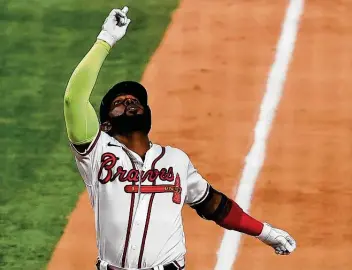  ?? Tom Pennington / Getty Images ?? Braves slugger Marcell Ozuna provided plenty of fireworks Thursday, going 4-for-5 at the plate and crushing a pair of homers to help Atlanta rout the Dodgers and move within one win of the World Series.