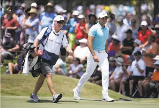  ?? Lynne Sladky / Associated Press ?? Jason Day of Australia (right) walks with his longtime caddie and coach, Colin Swatton, at The Players Championsh­ip in Florida in March. Swatton is the only coach Day has known.