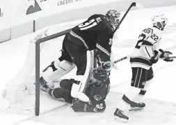  ?? ROB SCHUMACHER/THE REPUBLIC ?? Arizona Coyotes defenseman Jordan Oesterle (82) collides with goaltender Adin Hill (31) against the Los Angeles Kings in the second period Wednesday.