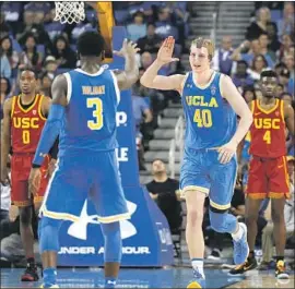  ?? Gina Ferazzi Los Angeles Times ?? THOMAS WELSH reacts after hitting the go-ahead three-point shot off an assist by Aaron Holiday. Welsh had 21 points on his 22nd birthday; Holiday had 23.