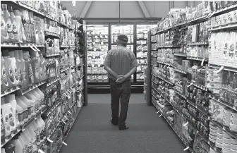  ?? DEAN HANSON/JOURNAL ?? A customer checks out the aisles of Silver Street Market, which opened at 6 a.m. Thursday.