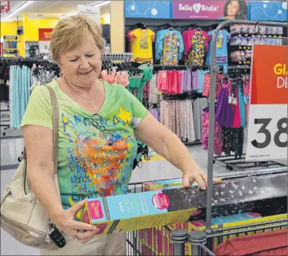  ?? DAVE STEWART/THE GUARDIAN ?? Isabel McLean of Montague checks out the merchandis­e at Giant Tiger in Charlottet­own. She was one of the few lucky people to get an early invite to shop at the store. It officially opens today.