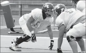  ?? NWA Democrat-Gazette/DAVID GOTTSCHALK ?? Nick Archer, center for the Alma High School football team, participat­es in a drill Tuesday at Airedale Stadium on the school’s campus in Alma.