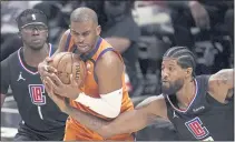  ?? MARK J. TERRILL — THE ASSOCIATED PRESS ?? Los Angeles Clippers guard Paul George, right, reaches in on Phoenix Suns guard Chris Paul during the second half in Game 6 of the Western Conference Finals on Wednesday in Los Angeles.